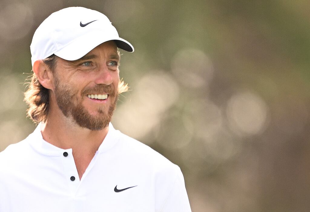 Tommy Fleetwood of England smiles on the 16th tee at Dubai Desert Classic. Photograph: Ross Kinnaird/Getty