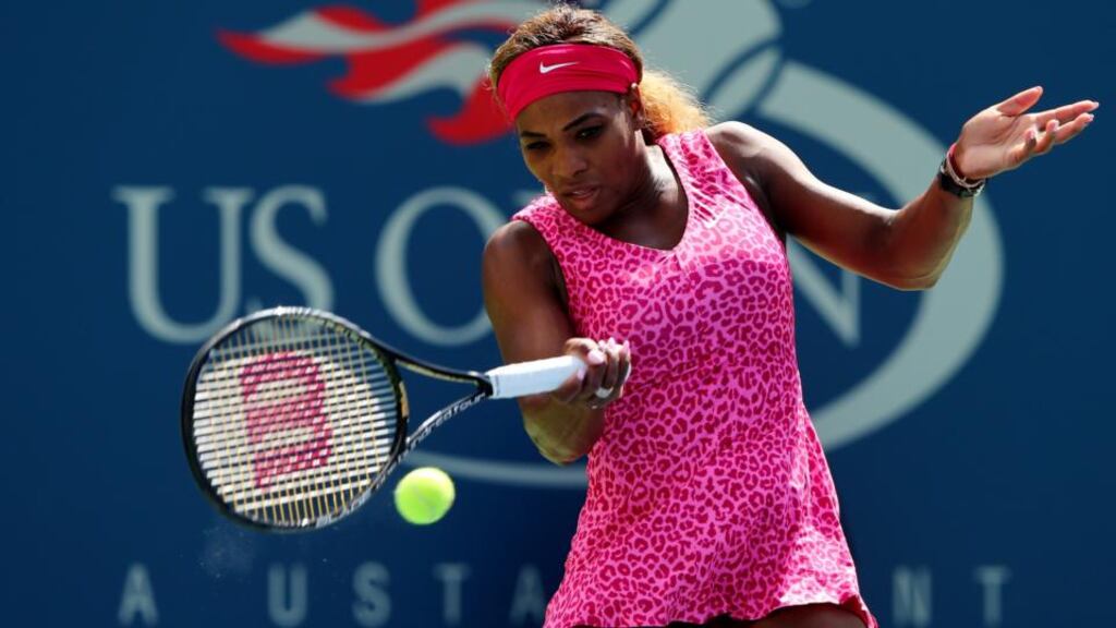 Serena Williams of the United States returns a shot against Vania King of the United States during their women’s singles second round match on Day Four of the 2014 US Open. Photograph: Elsa/Getty Images