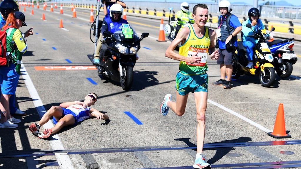 Australia’s Michael Shelley passes a prone Callum Hawkins of Scotland as he collapses after being in the lead of the Men’s Marathon Final at the XXI Commonwealth Games on the Gold Coast, Australia. Photograph: Tracey Nearmy/EPA