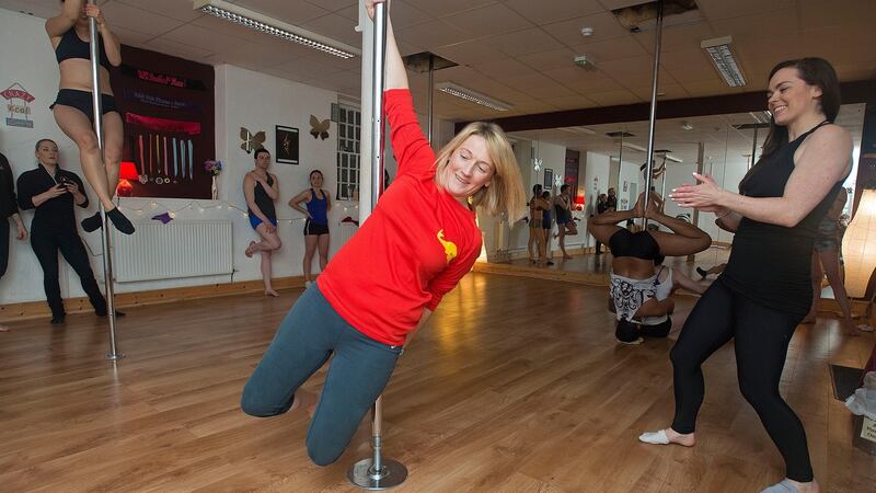 Fiona Alston is put through her paces by Sarah O’Reilly of Fierce Pole Fitness Dublin. Photograph: Dave Meehan/The Irish Times
