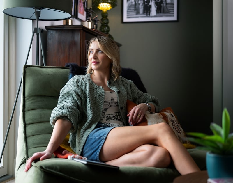 Louise relaxes in her recently painted room, colour drenched in DH Slate