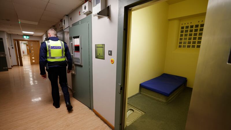 Sgt Eoghan Byrne passing the cell doors at Store Street Garda Station in Dublin’s city centre. Photograph: Alan Betson