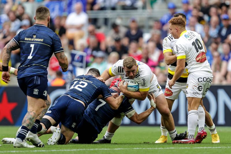 La Rochelle's Pierre Bougarit is tackled by Robbie Henshaw and Josh van der Flier of Leinster. Photograph: Laszlo Geczo/Inpho