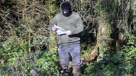 PSNI examine photo of masked man reading QIH death threat