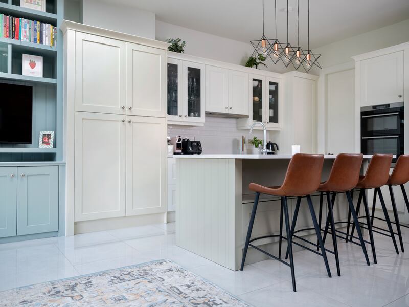 The island is painted in Dulux Heritage Setting Stone, while she chose Fresh Flour for the cabinets