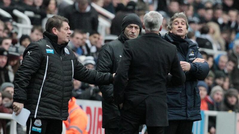 Newcastle manager Alan Pardew (c) argues with his Manchester City counterpart Manuel Pellegrini (r) at St James’s Park. Photograph: Lindsey Parnaby/EPA
