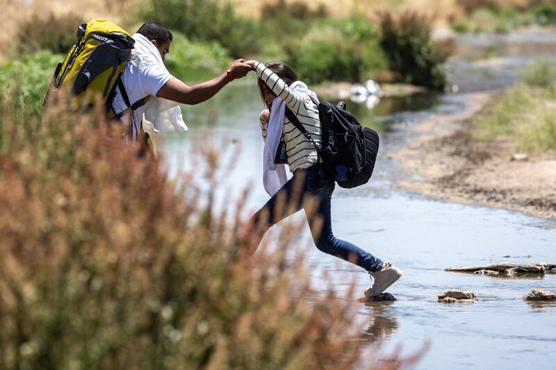Immigrants step across the Rio Grande from Mexico into the United States in El Paso, Texas. Photograph: John Moore/Getty Images