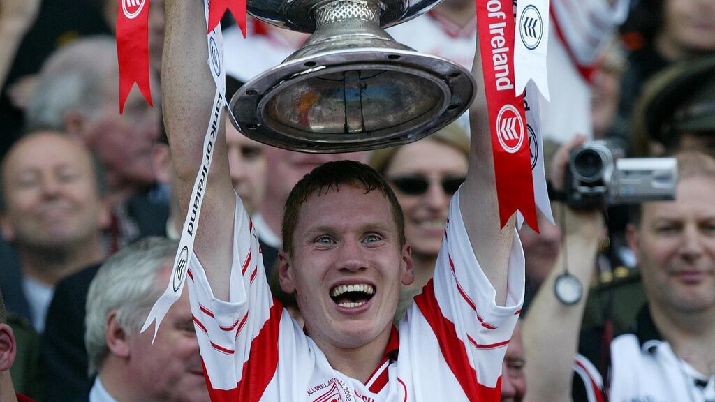 Tyrone’s Cormac McAnallen lifts the Sam Maguire after the All-Ireland final victory over Armagh in 2003. ©INPHO/Patrick Bolger