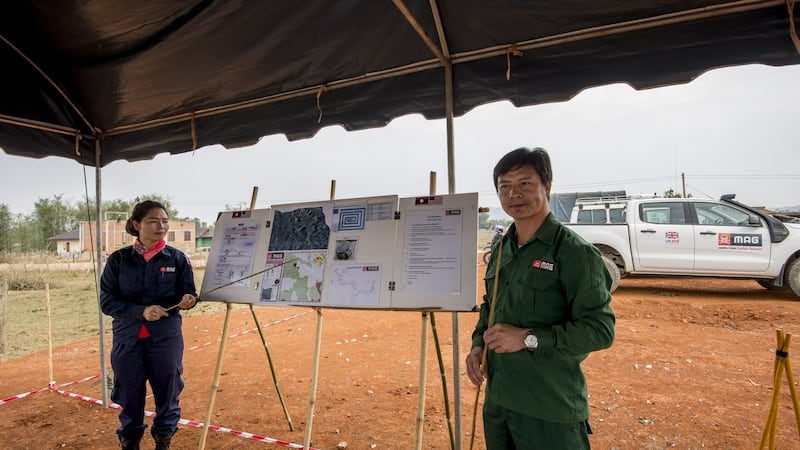 Staff of the Mines Advisory Group (MAG) prepare for the clearing of a rice field for a local farmer in Phonsavan, northeast Laos. Photograph: Brenda Fitzsimons