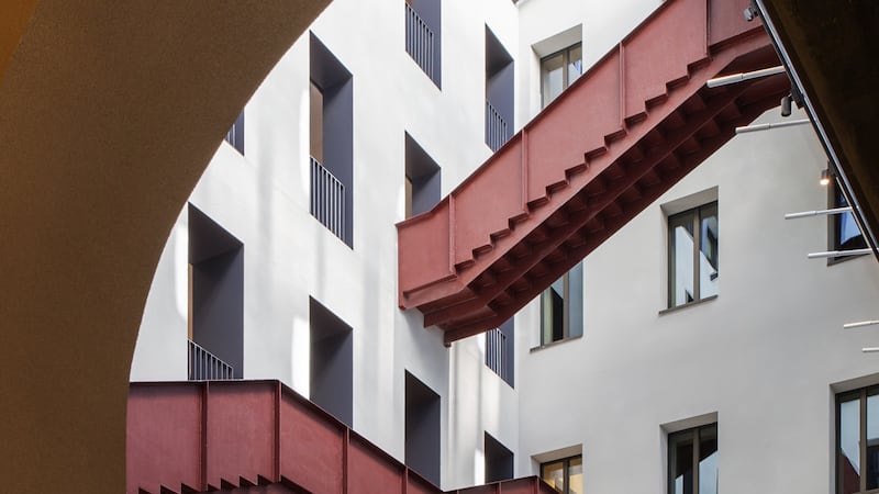 Red staircases running across walls at the Central European University in Budapest