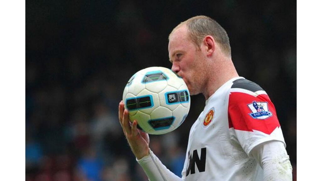 Manchester United's Wayne Rooney kisses the ball following his hat-trick during their 4-2 Premier League victory over West Ham at Upton Park. Photograph: Toby Melville/Reuters