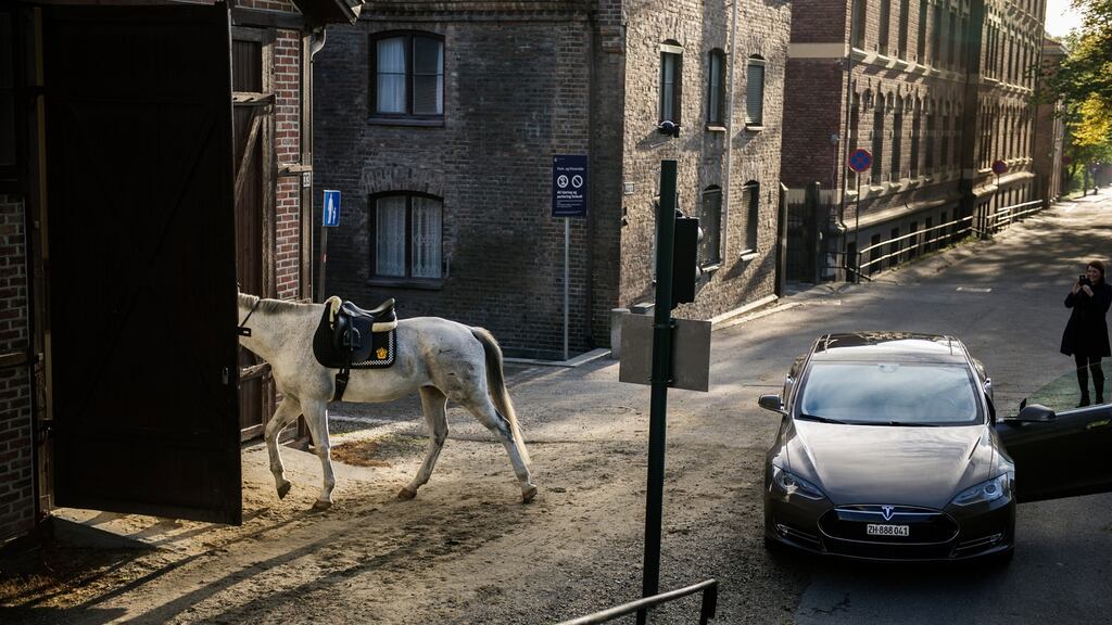 A car encounters a police horse near Oslo city centre, Norway. Photograph: Thomas Haugersveen/The New York Times