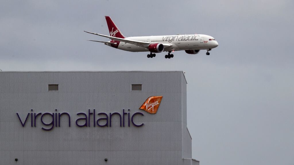 A Virgin Atlantic aircraft landing at Heathrow airport in England. The airline plans to cut 3,150 jobs and move its London Gatwick operations to the bigger Heathrow. Photograph: Steve Parsons/PA Wire