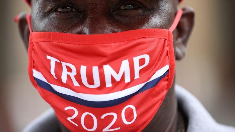 A supporter of US President Donald Trump wears a campaign hat and mask ahead of a rally at the BOK Center in Tulsa, Oklahoma. Photograph: Win McNamee/Getty Images