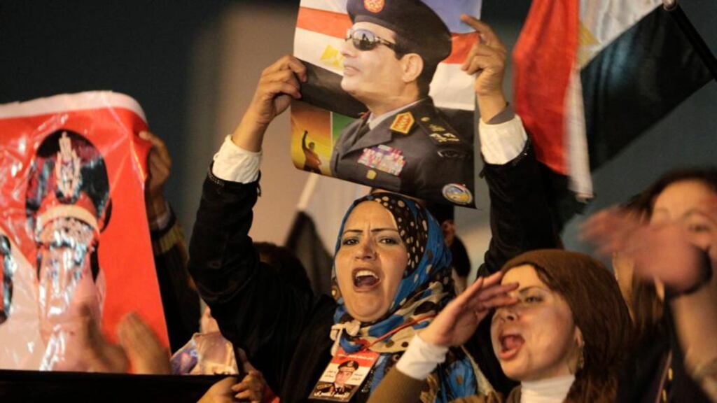 Supporters of Egypt’s army chief and defense minister General Abdel Fattah al-Sisi hold up posters of Sisi as they celebrate the passing of a new constitution at Tahrir Square in Cairo. Photograph: Mohamed Abd El Ghany/Reuters