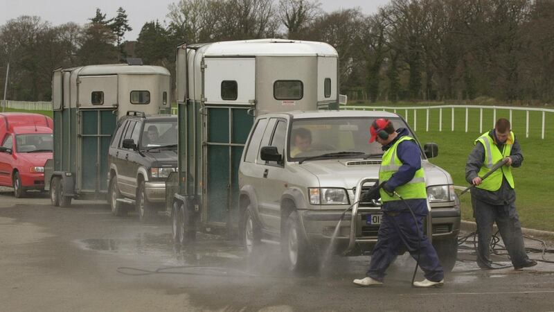 Horseboxes are sprayed on arrival at Leopardstown Racecourse where racing took place on April 15, 2001, after a seven-week break because of foot-and-mouth disease. Photograph: Bryan O’Brien