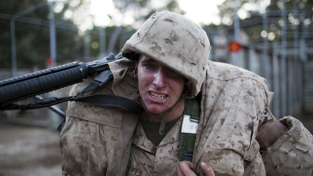 A US marine corps recruit training at Parris Island in South Carolina. One study found marines who failed basic training could pass when supported by a buddy system. Photograph: Robert Nickelsberg/Getty Images