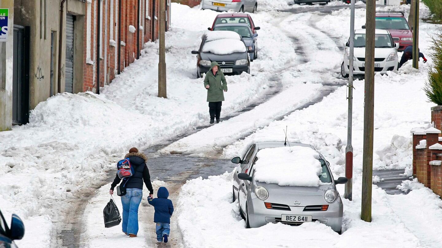 People walk through heavy snow in north Belfast  as wintry weather continues to cause havoc . Photograph: Reuters