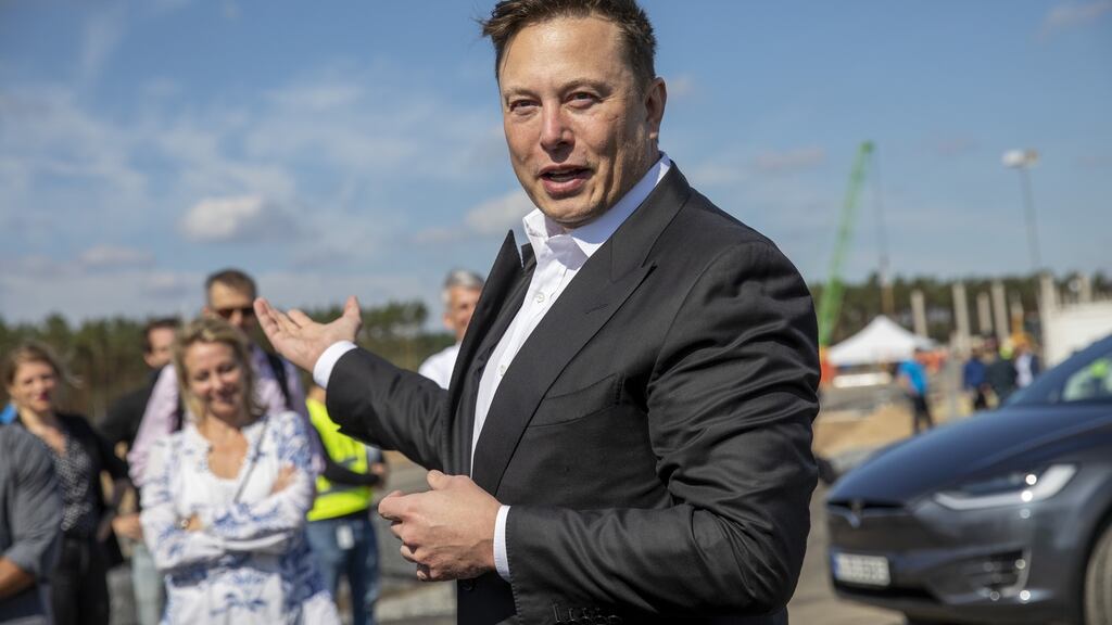 Elon Musk talks to the press as he arrives  at the construction site of the new Tesla factory near Berlin. Photograph:  Maja Hitij/Getty Images