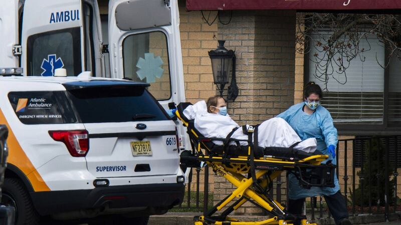 Medical workers take a patient from Andover Subacute and Rehabilitation Center into an ambulance in Andover, New Jersey. Photograph: Eduardo Munoz Alvarez/Getty Images