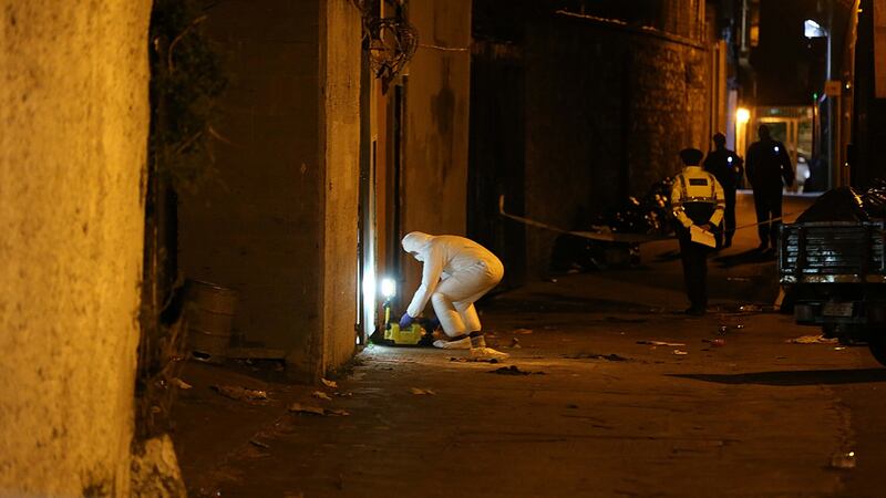 Gardaí preserve the scene where a man was shot in the leg at Horse Yard,Thomas St, near Vicar St in Dublin 8. Photograph: Stephen Collins/Collins Photos