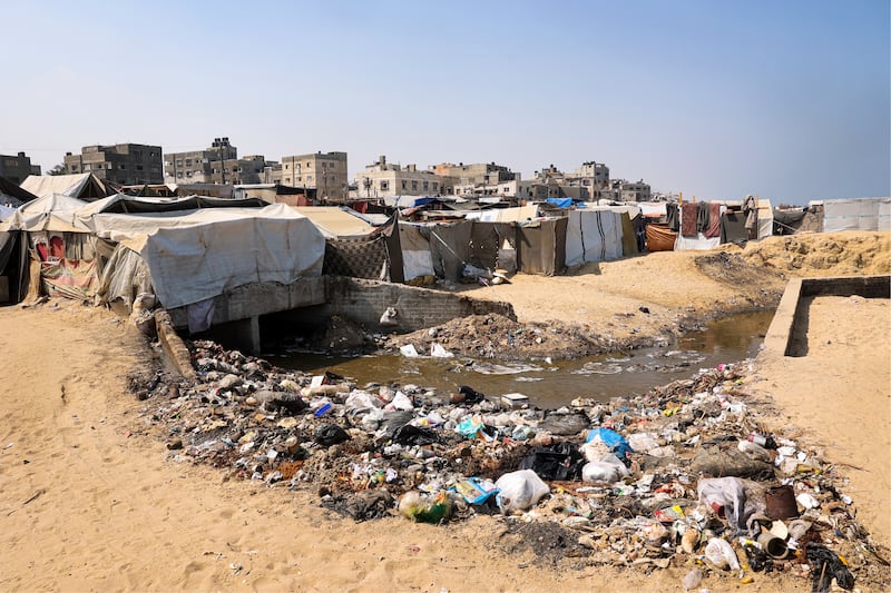Displaced Palestinians in Deir al-Balah on the coast of the central Gaza Strip, next to rubbish and raw sewage on Monday. Photograph: Eyad Baba/AFP