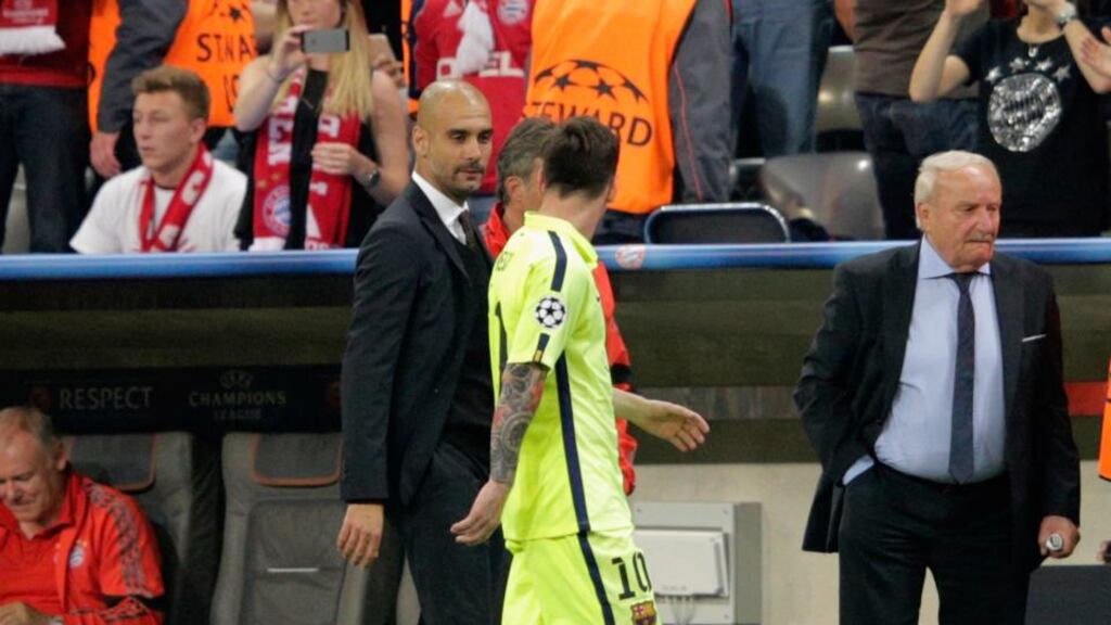Pep Guardiola speaks to Lionel Messi at half-time during the Champions League semi-final at the Allianz Arena. Photo: Adam Pretty/Bongarts/Getty Images