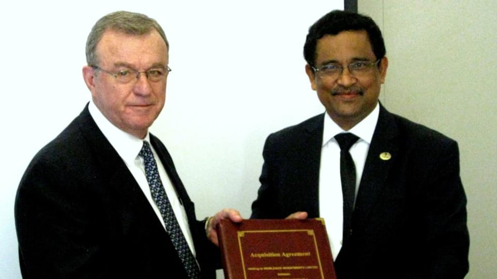 PetroNeft chief executive Dennis Francis and N. K. Bharali, director,  Oil Indiawith the signed farm out agreement for License 61