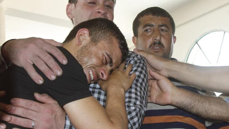 Relatives of 18-month-old Palestinian baby Ali Dawabsheh, who was killed after his family’s house was set on fire in a suspected attack by Jewish extremists, react during his funeral in Duma village near the West Bank city of Nablus. Photograph: Abed Omar Qusini/Retuers