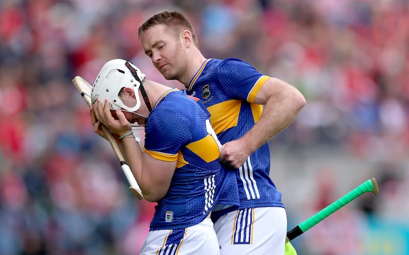 Tipperary’s Noel McGrath consoles Darragh McCarthy after he was sent off at the start of the game against Cork. Photograph: James Crombie/Inpho