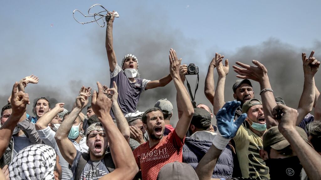Palestinian protesters near the border fence with Israel in the east of the Gaza Strip on Monday. Photograph: Mohammed Saber/EPA