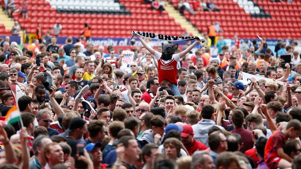 Burnley fans celebrate winning the league on the pitch after the Sky Bet Championship match against Charlton at The Valley. Photograph: Steve Paston/PA
