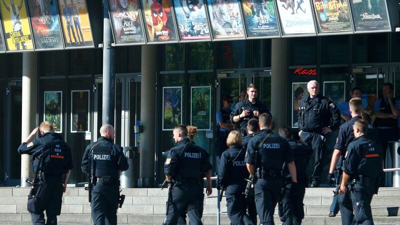 German police walk past a cinema complex after an armed man took hostages in the small western town of Viernheim, near Frankfurt, Germany. Photograph: Ralph Orlowski/Reuters