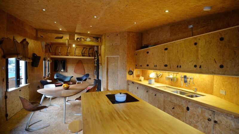 The walls, ceilings and floor are made out of oriented strand board, normally considered a packing material