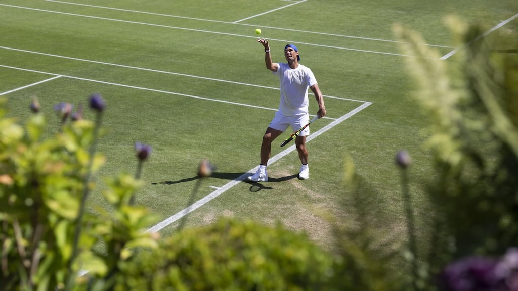 Rafael Nadal of Spain serves during a training session at the All England Lawn Tennis Championships in Wimbledon. Photo: Peter Klaunzer/EPA