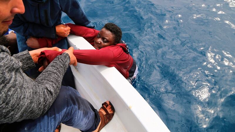 Libyan fishermen rescue a migrant from a sinking dinghy off the Libyan coast on March 20th. Photograph: Abdullah Elgamoudi/AFP/Getty Images