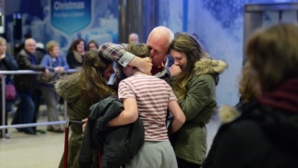 Gerard Corbett, arriving home from Saudi Arabia for Christmas, is meet by his children Ellen (20), Faye (17) and Dominic (15) at Dublin Airport early this morning. Photograph: Dara Mac Dónaill / The Irish Times