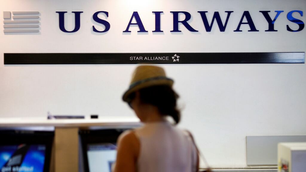 A traveller checks in for a US Airways flight at Long Beach Airport, California in July. Photograph: Patrick T. Fallon/Bloomberg