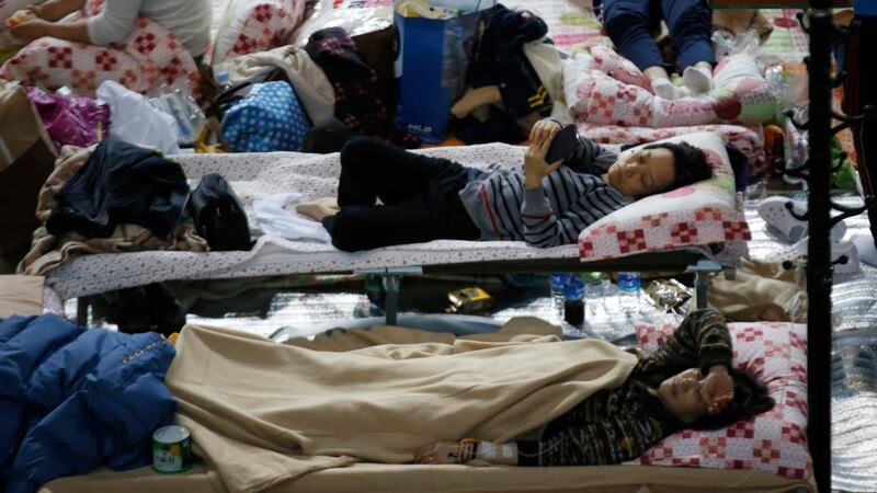 Family members of missing passengers rest at a gym as they wait for news from the rescue team, in Jindo. Photograph: Kim Kyung-Hoon/EPA