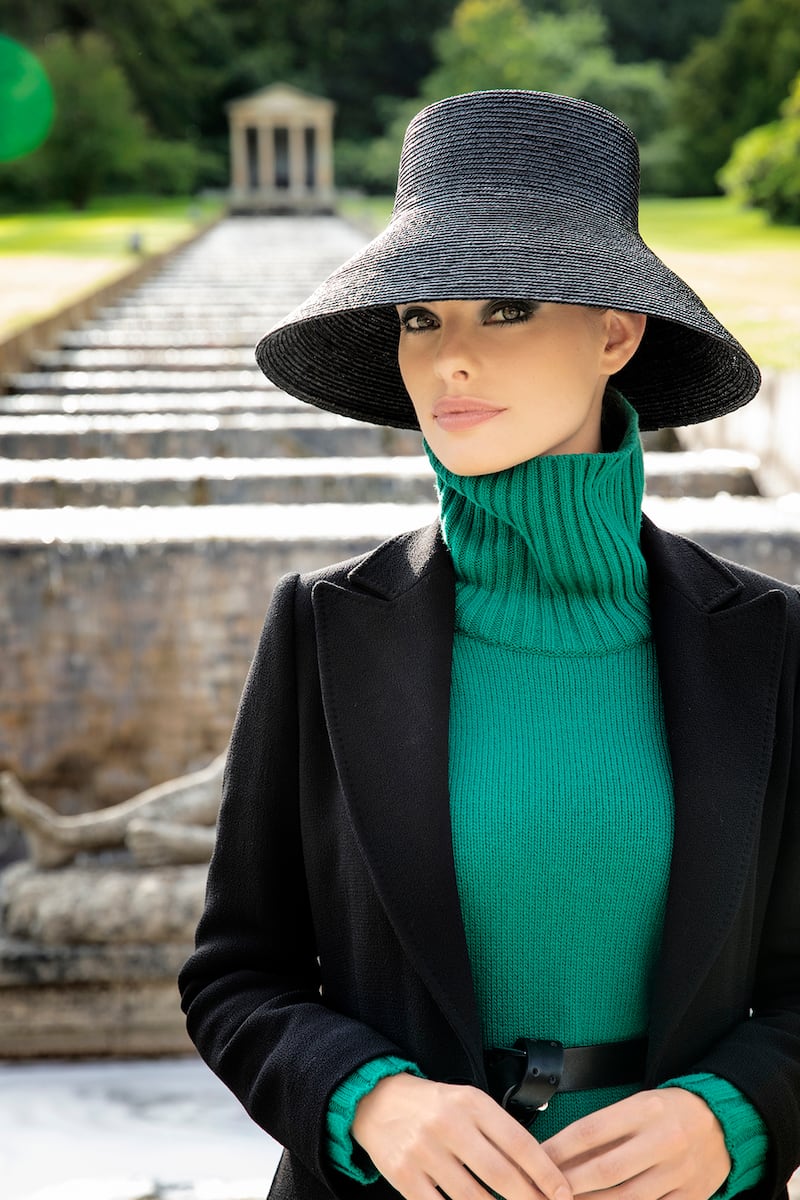 Louise Kennedy: Aisha green lambswool sweater €595, Alix coat in wool double crepe €1,295. Bucket hat by Anthony Peto