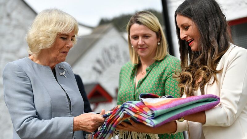 Camilla, Duchess of Cornwall receives a gift of a blanket for the Duke and Duchess of Sussex’s son Archie as she visits the Avoca Mill. Photograph: Neil Hall/Pool/Getty Images