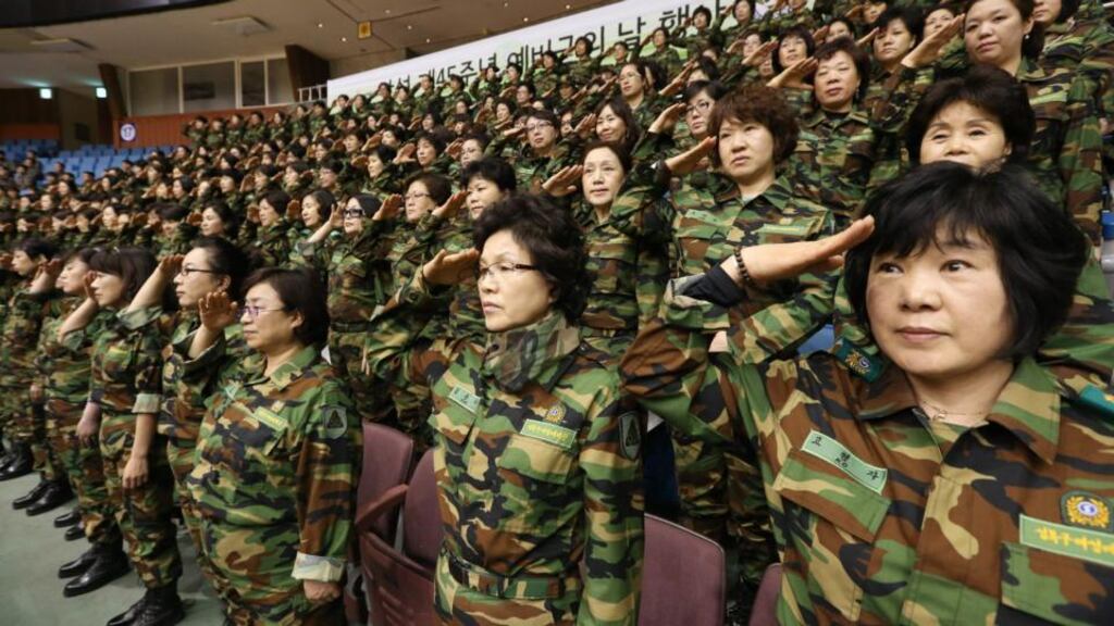 Army reservists salute the flag during a Foundation Day ceremony of the local reserve forces in Seoul today. North Korea has placed two of its intermediate range missiles on mobile launchers and hidden them on the east coast of the country in a move that could threaten Japan or US Pacific bases, South Korean media has reported. Photograph: Lim Hun-jung/Reuters