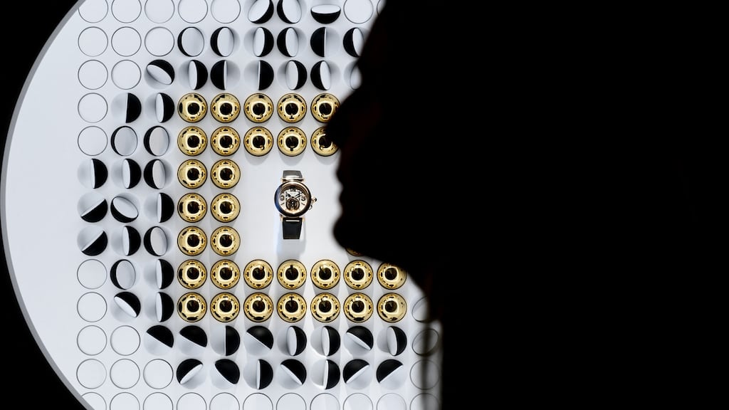 A women walks past a watch displayed in a window of French luxury goods Cartier, owned by Richemont group. Photograph: Fabrice Coffrini/AFP via Getty Images