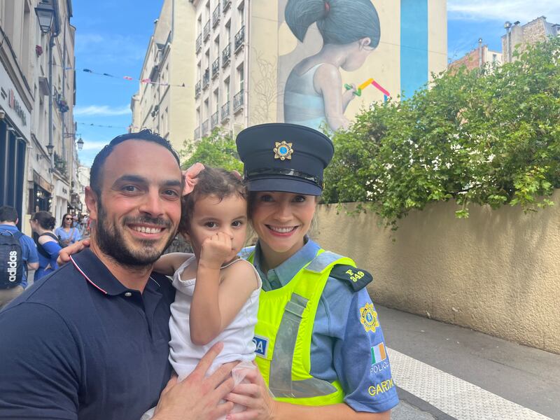 Mahmoud Bakrawie and his two-year-old daughter Raya, from Palestine, with Garda Marion Power in Paris. Photograph: Jack Power