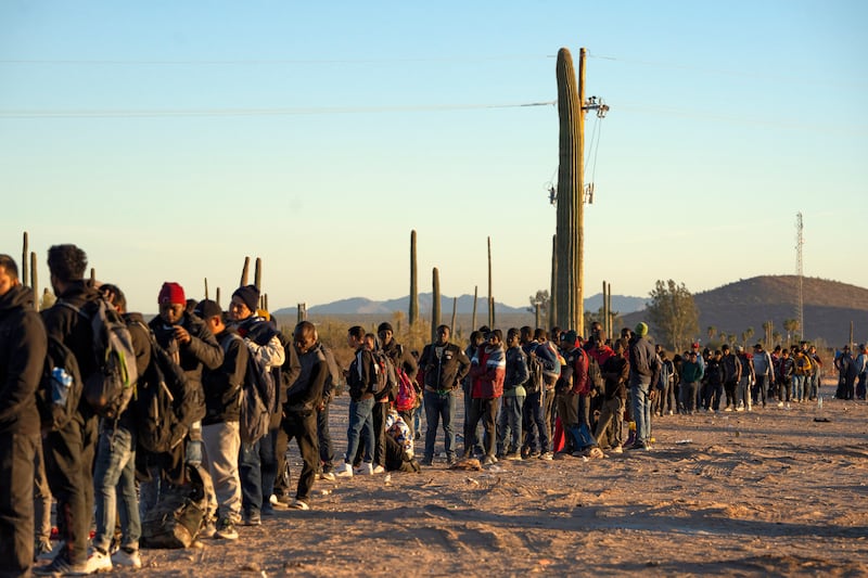 A line of migrants await processing by the US Border Patrol near Lukeville, Arizona, in December. Photograph: Rebecca Noble/New York Times