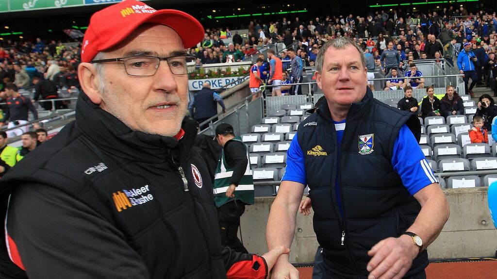 Tyrone’s Mickey Harte and Cavan manager Terry Hyland shake hands after the game. Photograph: Lorraine O’Sullivan/Inpho
