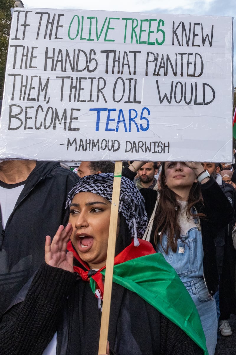A protester holds a sign bearing a quotation from poet Mahmoud Darwish during a march in London to call for a ceasefire in Gaza in October 2023. Photograph: Mark Kerrison/In Pictures via Getty Images