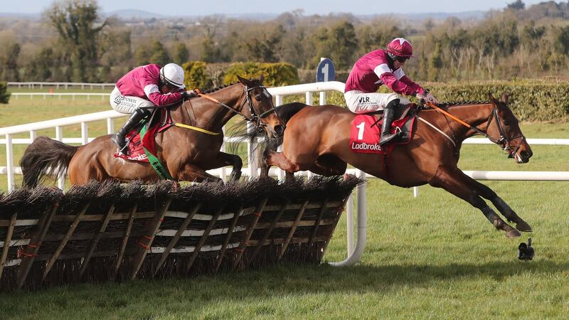 Beacon Edge ridden by Sean Flanagan (left) jumps the last before beating Fury Road and Jack Kennedy (right) to win. Photo: Niall Carson/PA Wire
