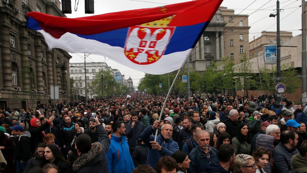 A Serbian flag held aloft during a protest march against President Aleksandar Vucic in Belgrade on Saturday. Photograph: Darko Vojinovic