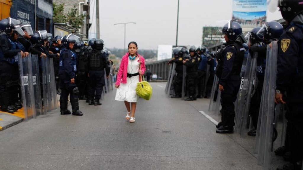 Riot police guard one of the access roads to Benito Juárez International airport after demonstrators staged a protest over the 43 missing students in Mexico City yesterday. Photograph: Tomas Bravo/Reuters